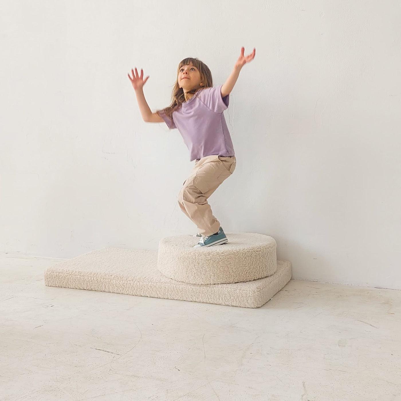 girl playing on boucle mattress and boucle pouf by bettys home, teddy boucle mattress for modern nursery