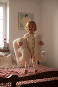 cute boy standing on bed with boucle letter cushion B and J teddy pillow by bettys home in his hands as birthday gift 