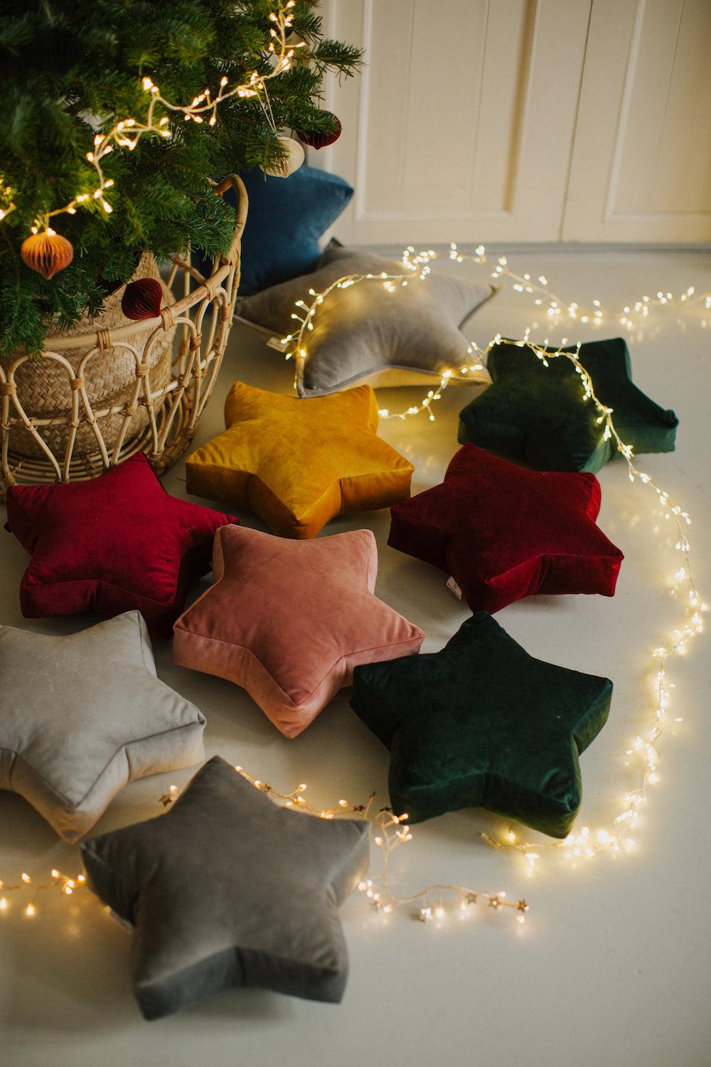 velvet small star cushion wine red by bettys home among other small stars next to christmas tree