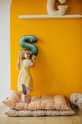 child playing in her room with velvet letter cushion s mint by bettys home