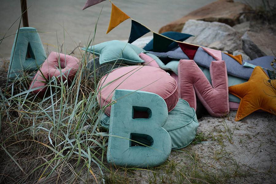 letter pillow b mint on sand on beach by Bettys home