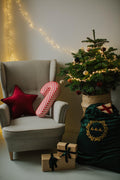 velvet star cushion wine red by bettys home on armchair under velvet star garland next to christmas tree