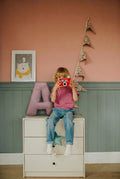 boy sitting next to corduroy letter cushion A by bettys home 