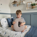 boy sitting on bed with letter cushion G mocha by Bettys home 