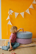 large corduroy floor pouf blue and lavender by Bettys home. small boy playing on poufs