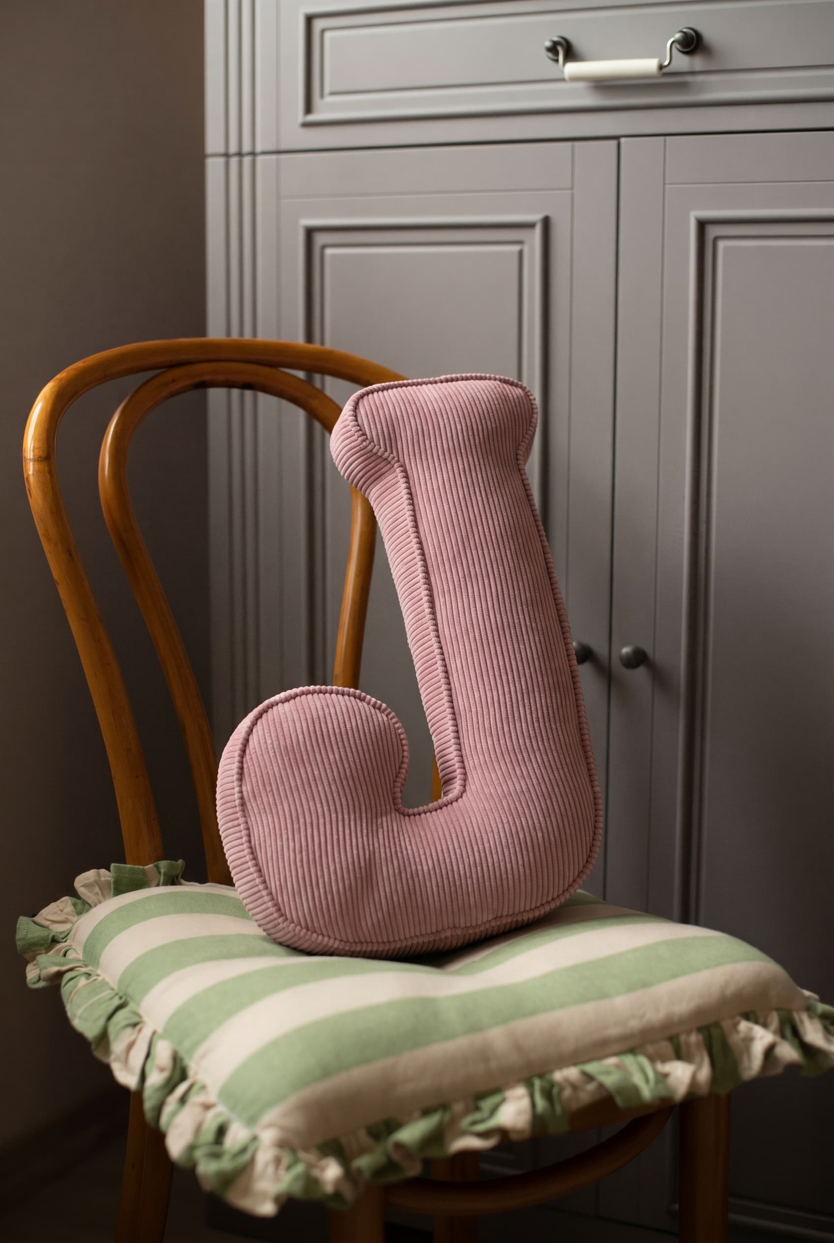 corduroy letter cushion J by bettys home in kids room on chair. Cushion in shape of letter