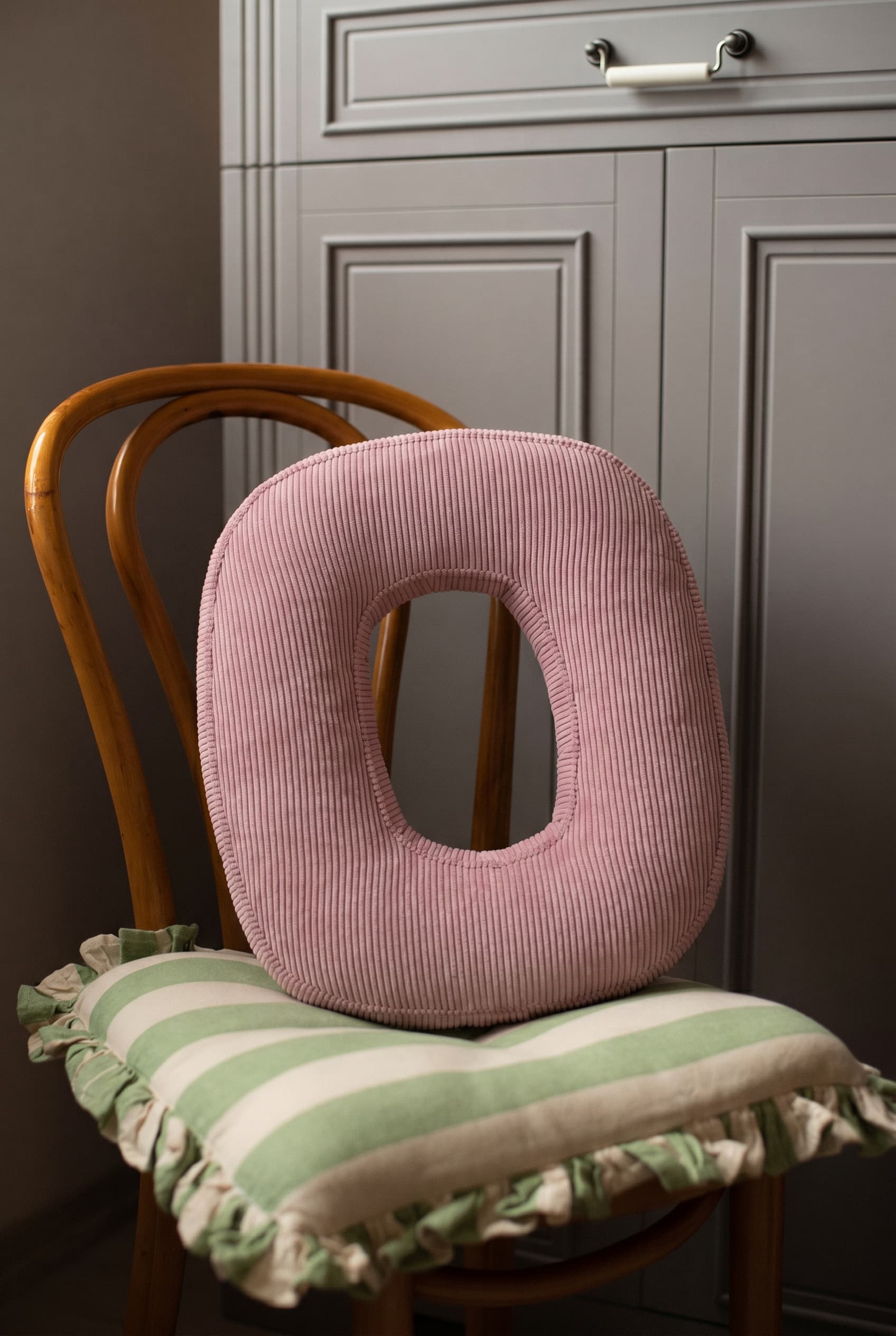 corduroy letter cushion O by bettys home in kids room on chair. Cushion in shape of letter