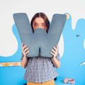 Girl with corduroy letter cushion W by Bettys home in hands 