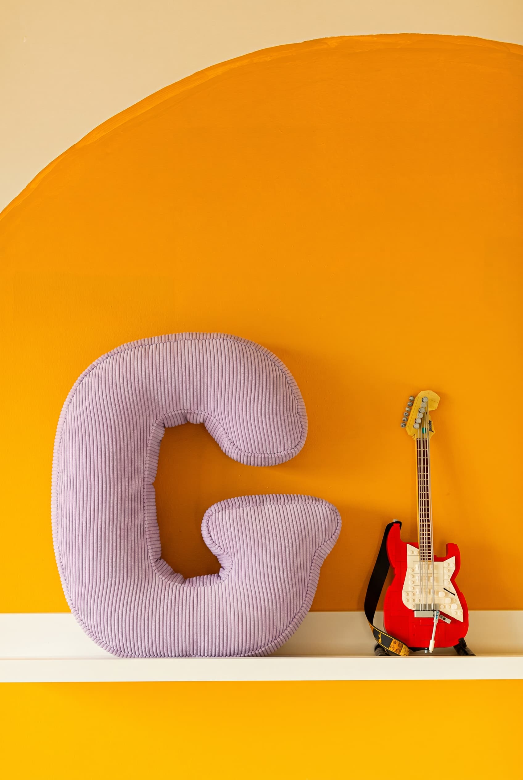 corduroy letter cushion g by bettys home in kids room on shelf and yellow wall