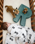 Velvet Letter Cushion R by Bettys Home in kids crib next to sleeping child