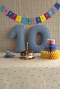 Corduroy Number Cushion by Bettys Home on birthday table with cake