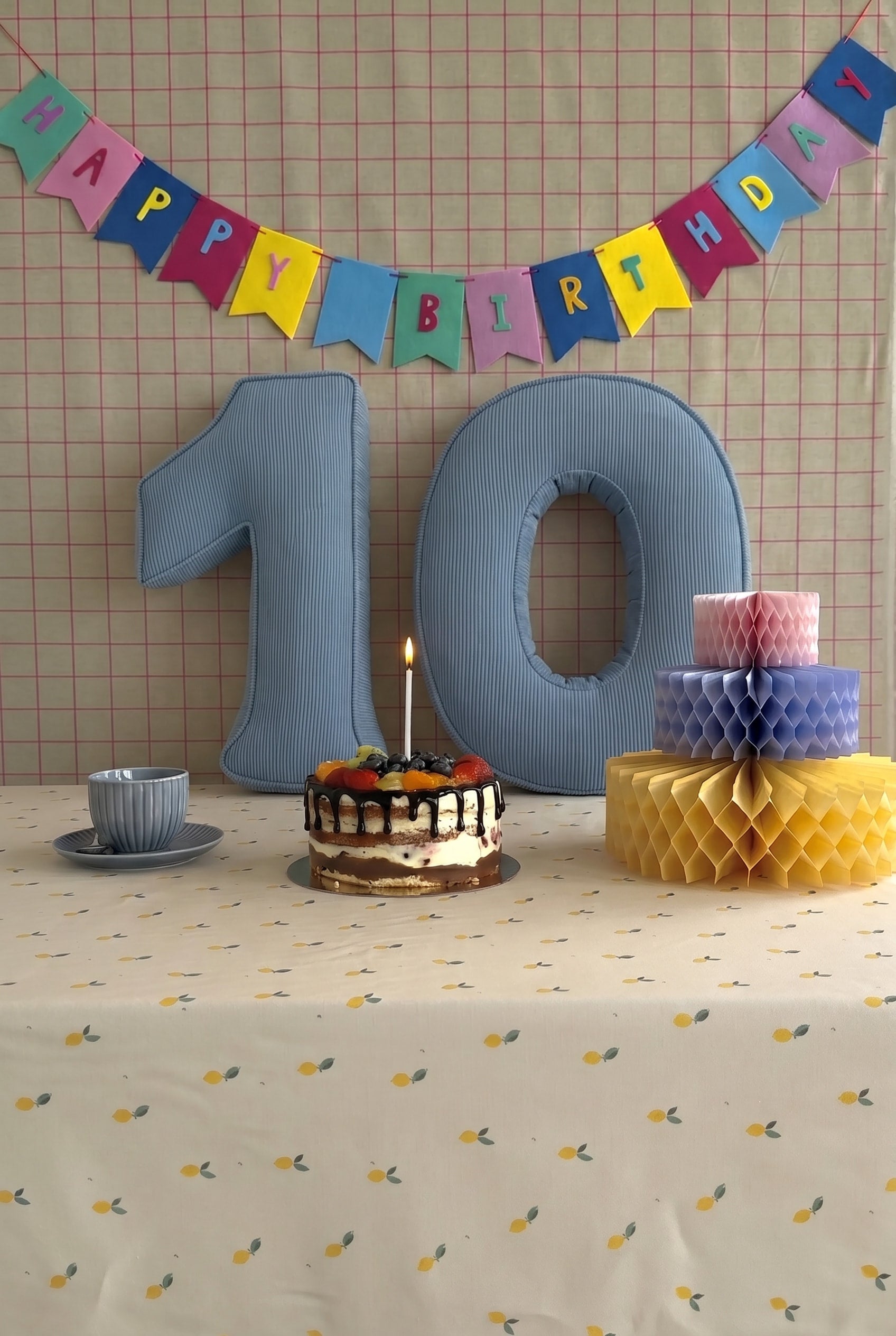 Corduroy Number Cushion by Bettys Home on birthday table with cake