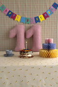 Corduroy Number Cushion by Bettys Home on birthday table with cake