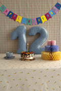 Corduroy Number Cushion by Bettys Home on birthday table with cake
