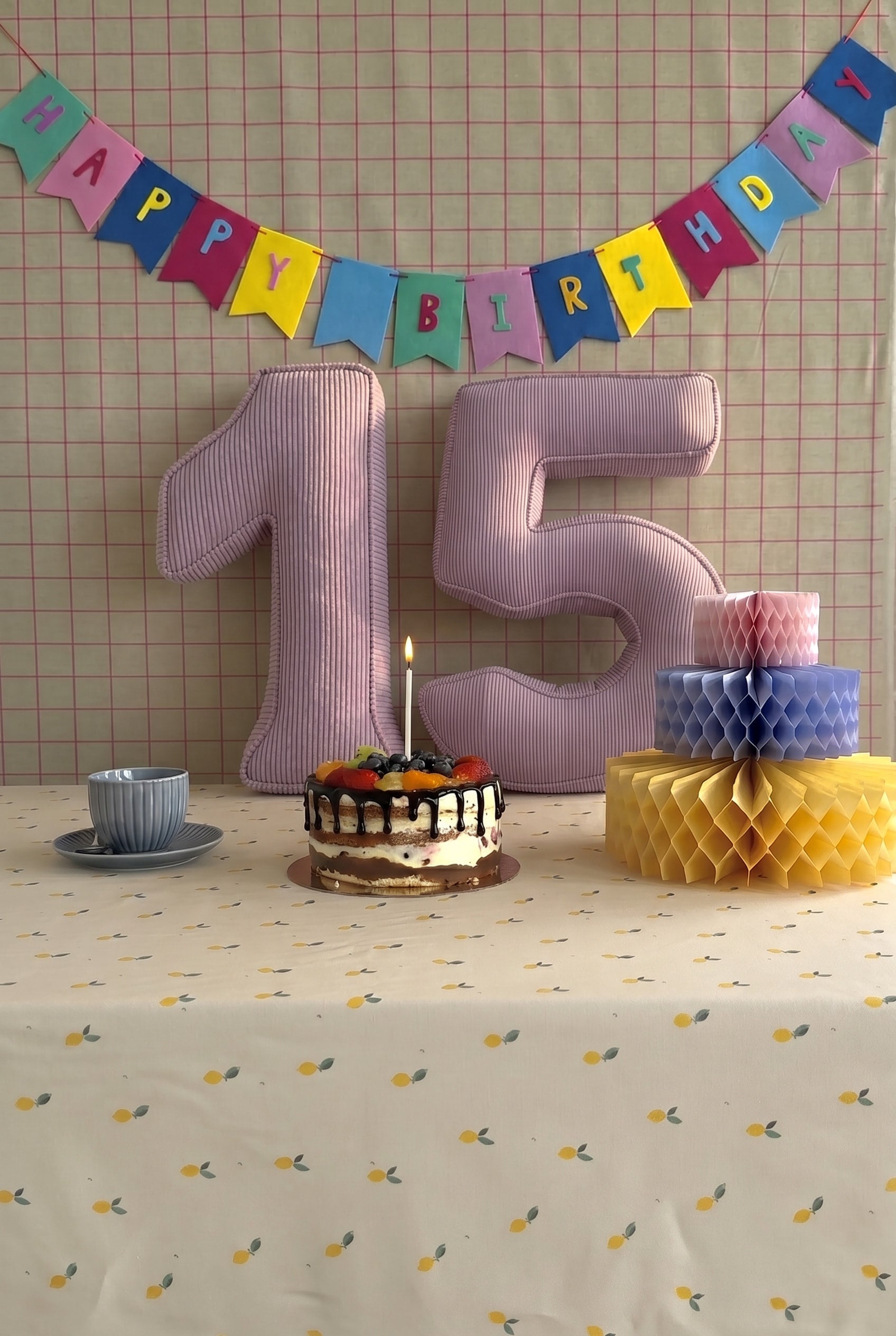 Corduroy Number Cushion by Bettys Home on birthday table with cake