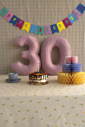 Corduroy Number Cushion by Bettys Home on birthday table with cake