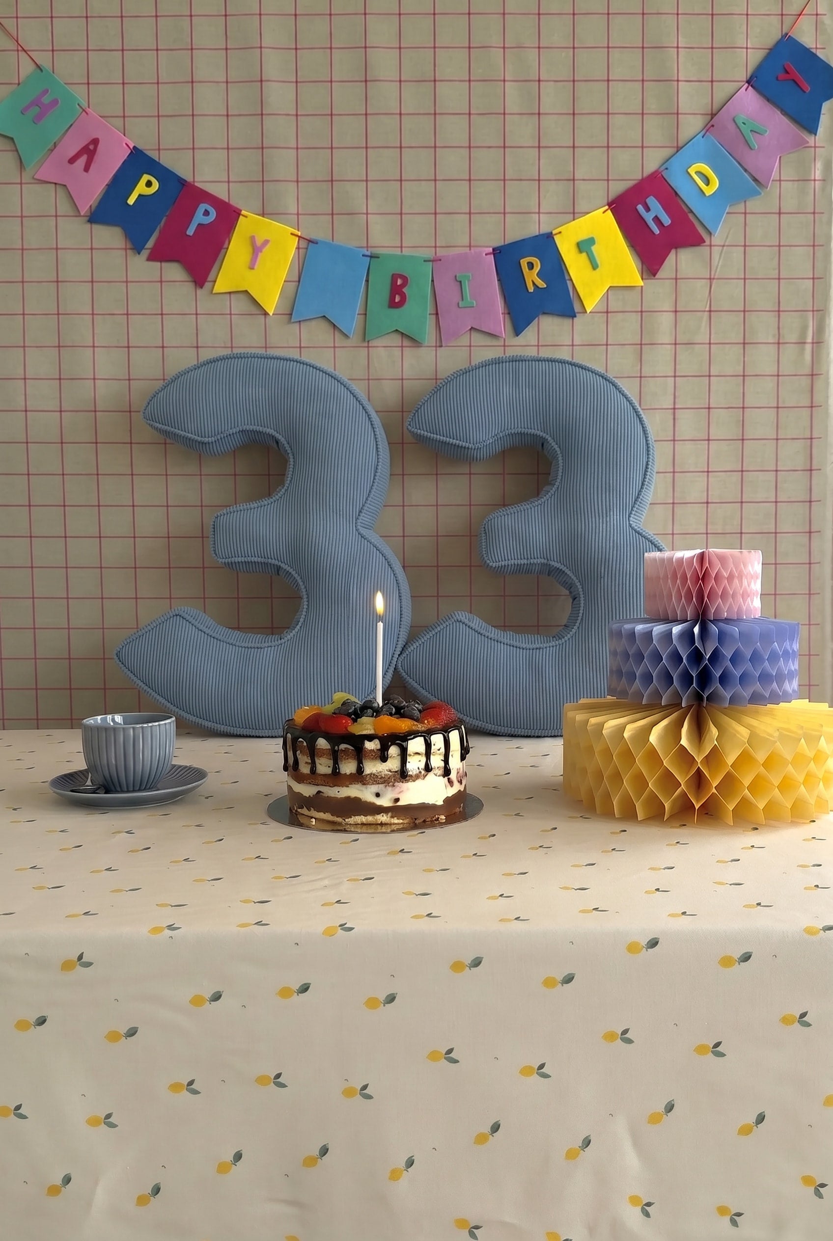 Corduroy Number Cushion by Bettys Home on birthday table with cake