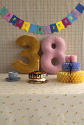 Corduroy and Velvet Number Cushion by Bettys Home on birthday table with cake
