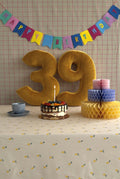 Velvet Number Cushion by Bettys Home on birthday table with cake