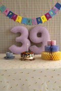 Corduroy Number Cushion by Bettys Home on birthday table with cake