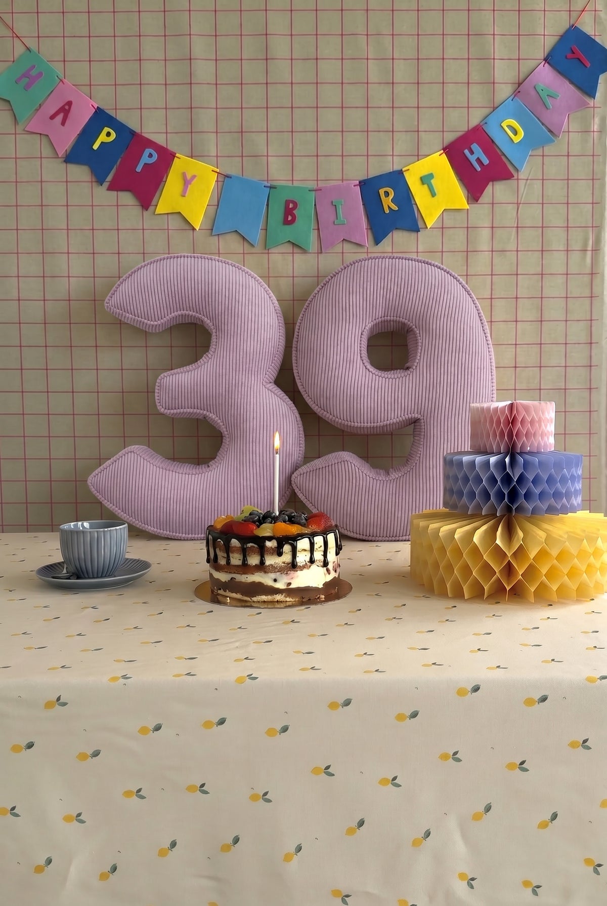 Corduroy Number Cushion by Bettys Home on birthday table with cake