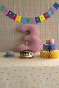 Corduroy Number Cushion by Bettys Home on birthday table with cake