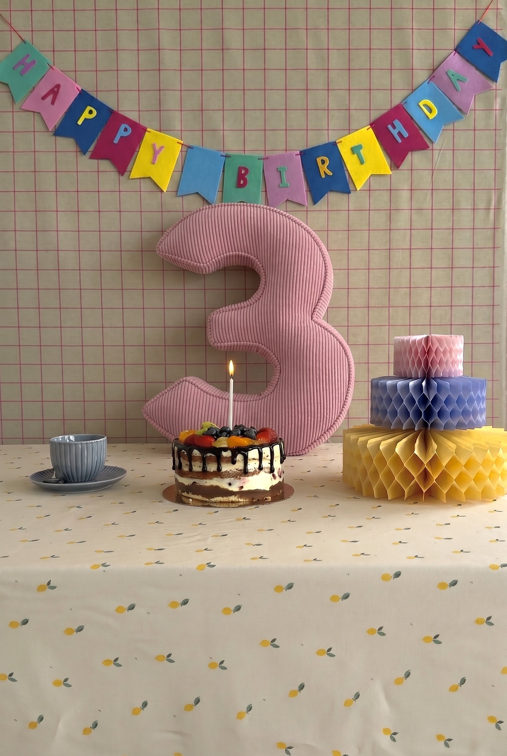 Corduroy Number Cushion by Bettys Home on birthday table with cake