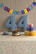 Corduroy Number Cushion by Bettys Home on birthday table with cake