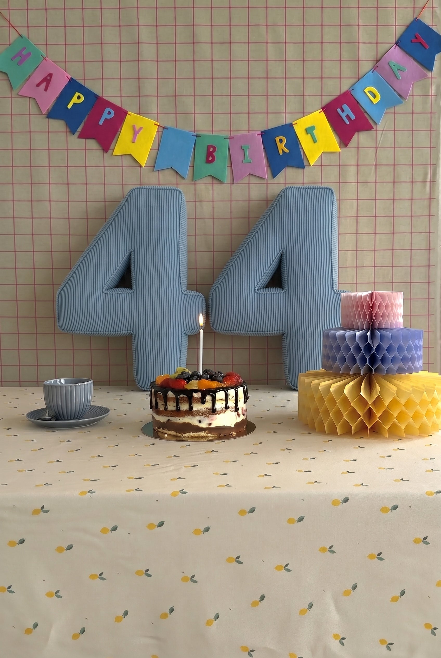 Corduroy Number Cushion by Bettys Home on birthday table with cake