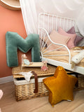 small star cushion in yellow by bettys home next to letter cushion M