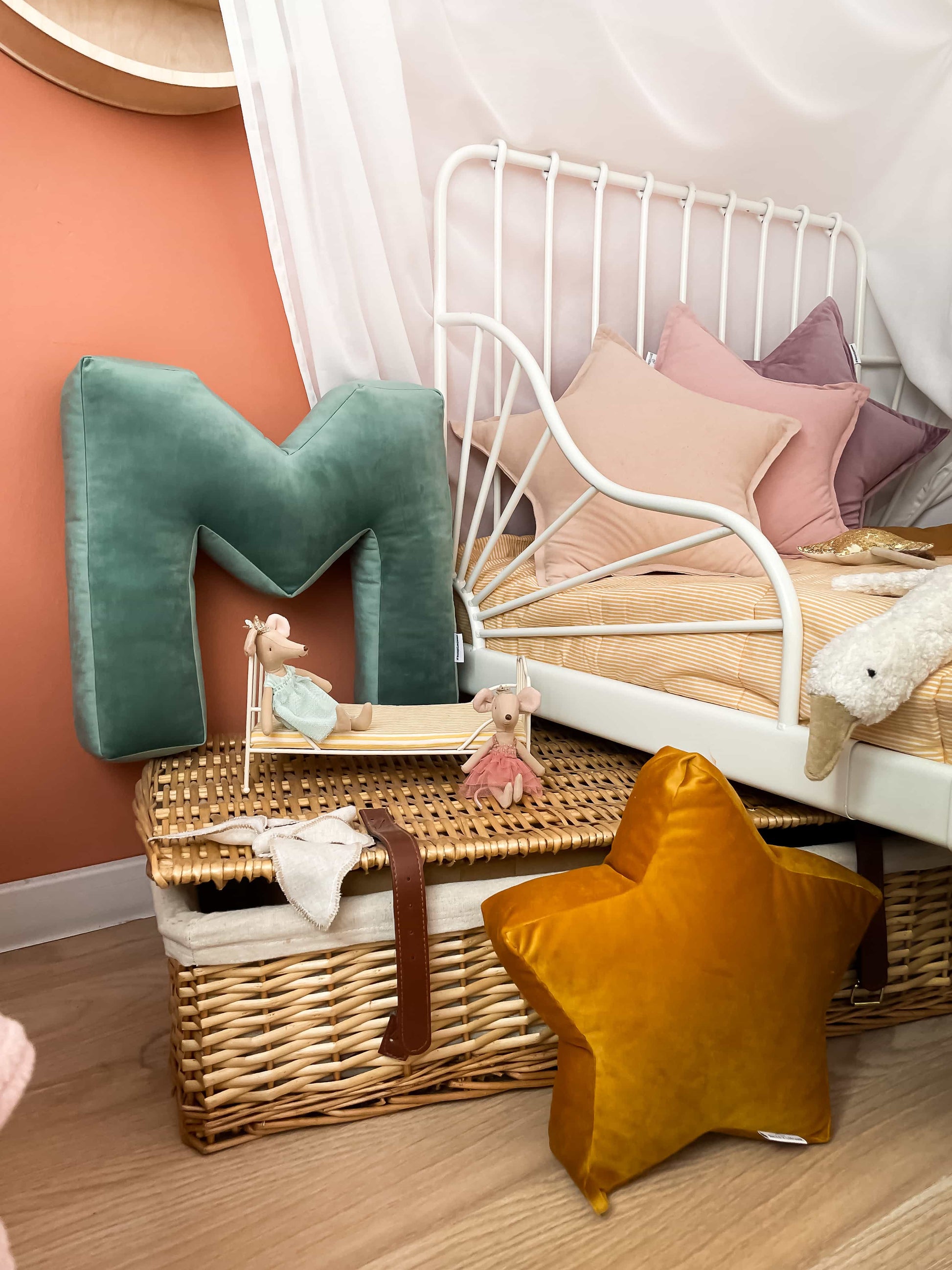 small star cushion in yellow by bettys home next to letter cushion M