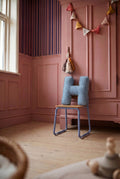 corduroy letter cushion H by bettys home in kids room on chair and pink wall 