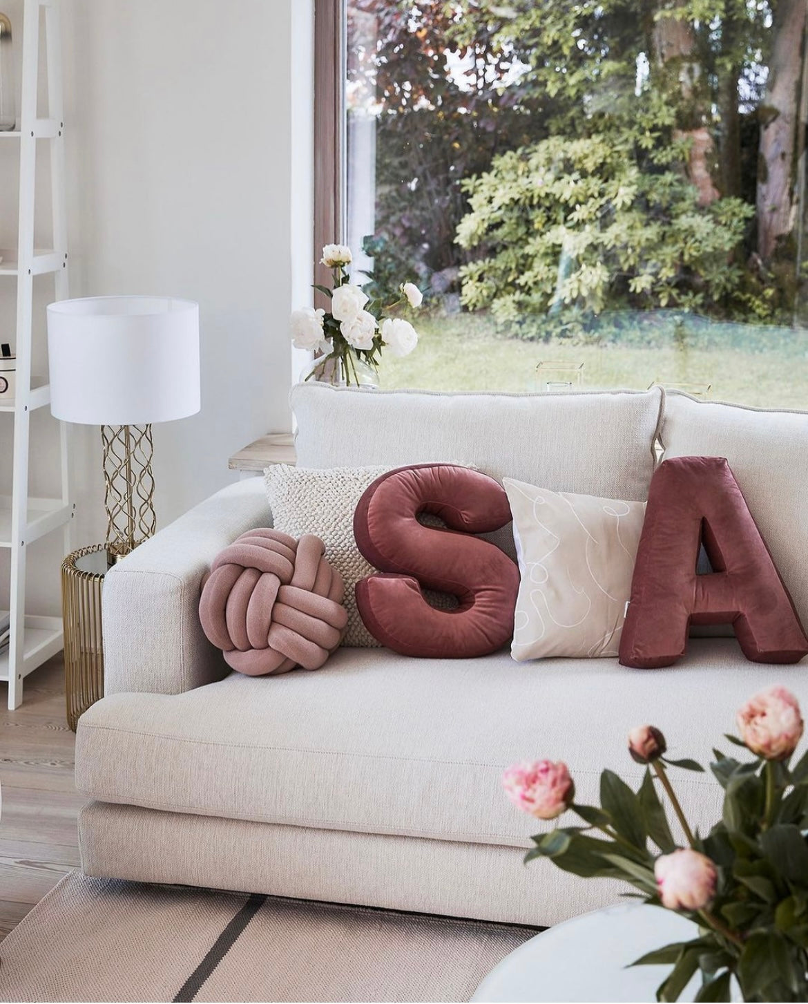 velvet letters cushion S and A in living room on creme sofa. Letter cushions by bettys home